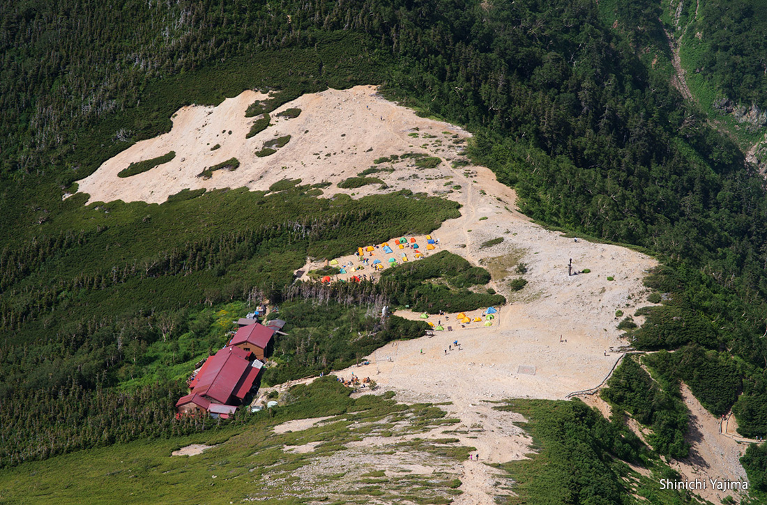 Jonengoya Mountain Hut located within a mountain col.